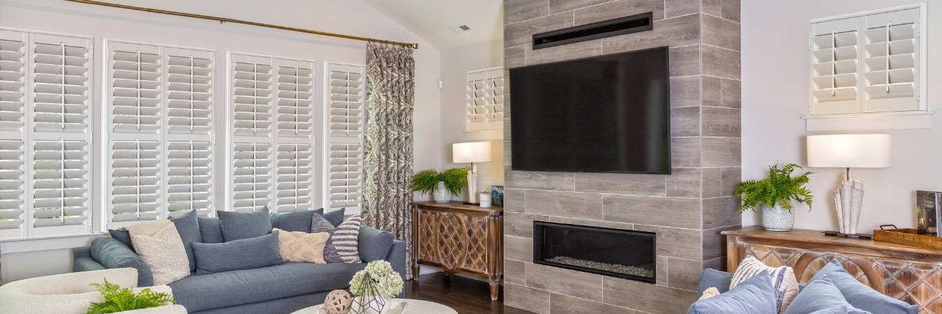 Interior shutters in Tioga living room with fireplace
