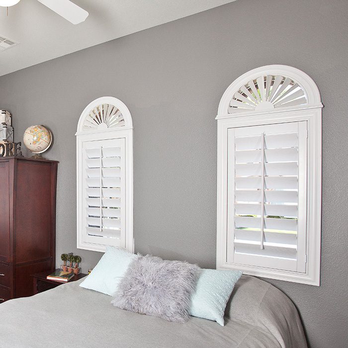 White arched shutters in a teen bedroom.