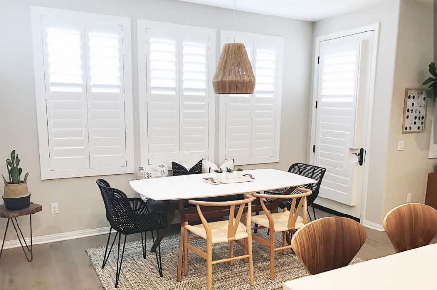 Polywood shutters with top louvers tilted open in a dining room