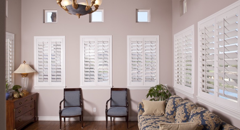 Modern sunroom with white shutters