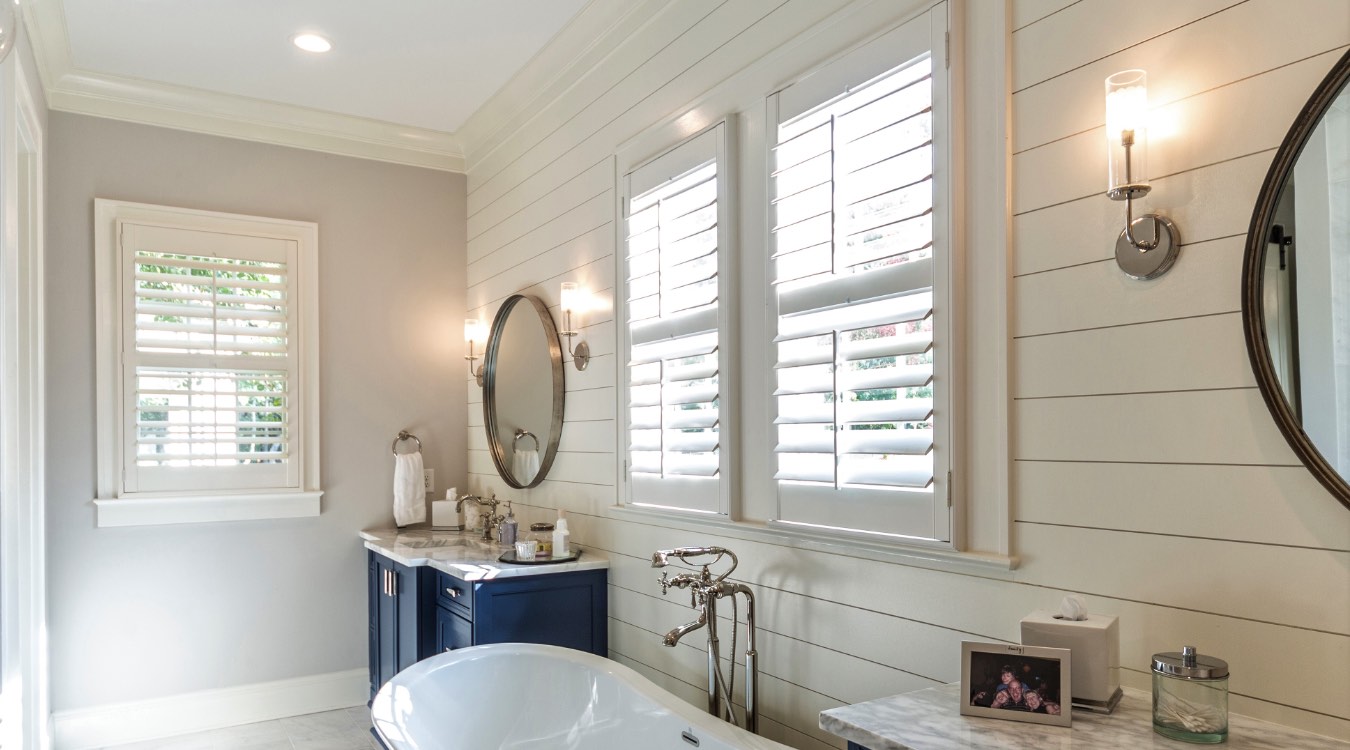 Gainesville bathroom with white plantation shutters.