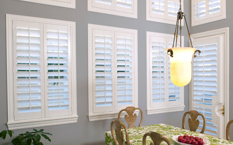White polywood shutters in a dining room.